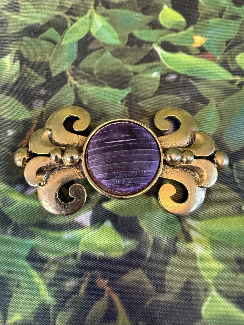 Vintage 80’s Carol Dauplaise Gold-Tone Scroll Brooch with Purple Center